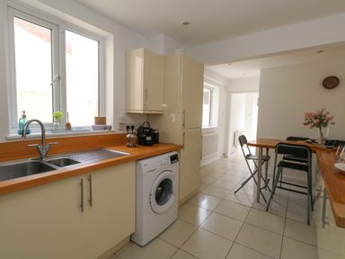 A kitchen with a washing machine and countertop at Weymouth Seaside House in Weymouth