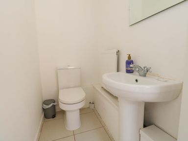 A bathroom with a toilet and sink at Weymouth Seaside House in Weymouth