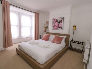A bedroom with a bed and a window at Weymouth Seaside House in Weymouth