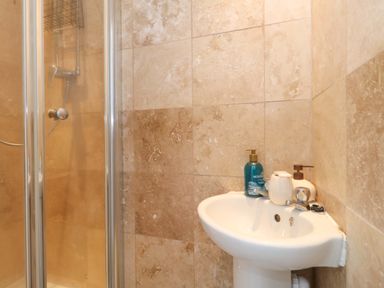 A bathroom with a shower and sink at Weymouth Seaside House in Weymouth