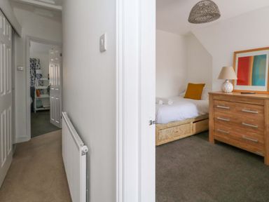 A bedroom with a bed and dresser at Weymouth Seaside House in Weymouth