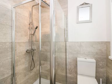 A bathroom with a glass shower enclosure and a toilet at Serenity Skiptory Howe 10 White Cross Bay near Windermere