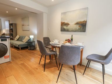 A dining room with a table set for a meal at Harbourside in Weymouth