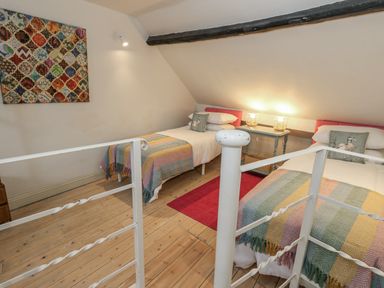 A bedroom with two beds and a nightstand at Harbourside in Weymouth