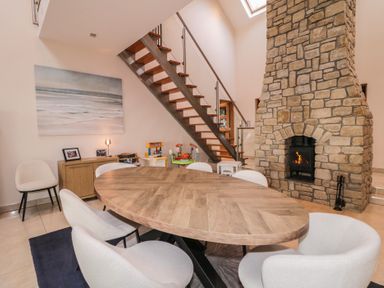 A dining room with a round table and chairs at Ard Na Mara Drung near Quigley's Point, County Donegal