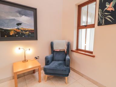A snug with an armchair and side table at Ard Na Mara Drung near Quigley's Point County Donegal
