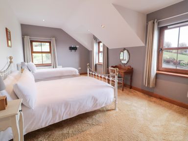 A bedroom with a bed and a window at Ard Na Mara in Drung near Quigley's Point, County Donegal