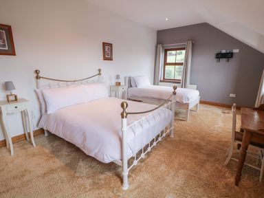 A bedroom with a double bed and single bed at Ard Na Mara Drung near Quigley's Point, County Donegal