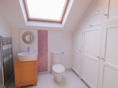 A bathroom with a sink, toilet and a towel radiator at Ard Na Mara in Drung near Quigley's Point, County Donegal