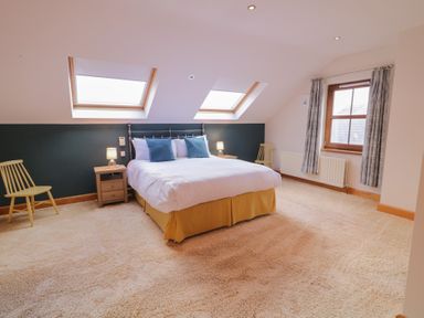 A bedroom with a bed and a chair at Ard Na Mara Drung near Quigley's Point County Donegal