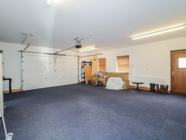 A garage with shelving units and storage boxes at Ard Na Mara in Drung near Quigley's Point, County Donegal