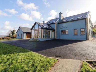 An outdoor view of a house with a garage and driveway at Ard Na Mara in Drung near Quigley's Point, County Donegal