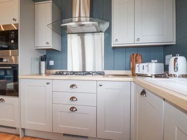 A kitchen with stove oven toaster kettle and cabinets at 6 Meadow Retreat in Dobwalls