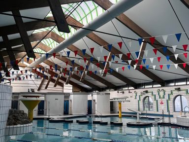 An indoor pool with diving board and lane markers at Valley Lodge 38 St Ann's Chapel, Cornwall