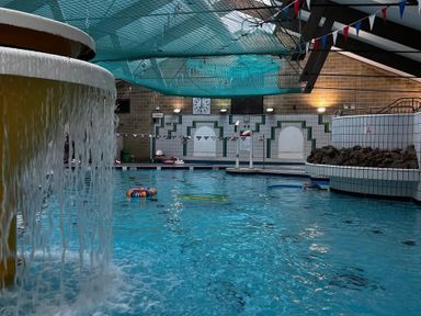 A swimming pool with a water feature and swim lanes at Valley Lodge 38, St Ann's Chapel, Cornwall