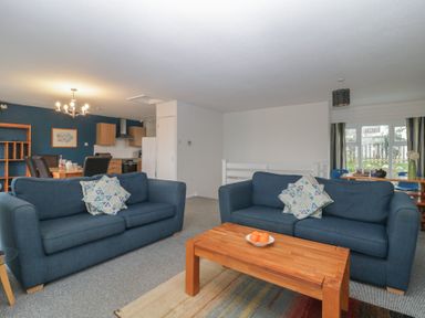 A living room with two blue sofas and a wooden coffee table at Tamar Cottages 34 St Ann's Chapel Cornwall