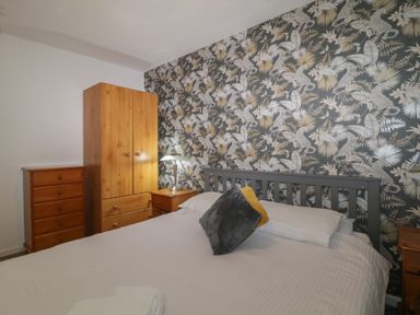 A bedroom with a bed pillows wardrobes drawers and a lamp at Tamar Cottages 34 in St Ann's Chapel Cornwall