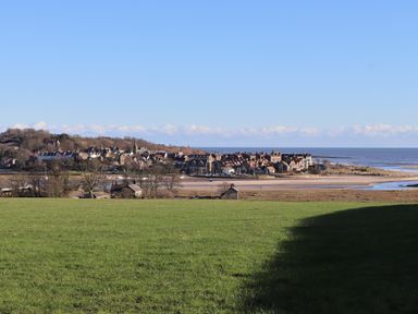 A coastal view with houses and water at Seafield Granary in Alnmouth