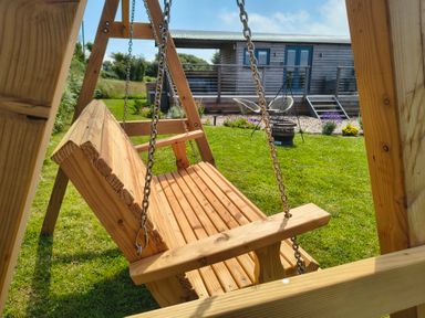 A swing in a garden at Fir Tree Shepherd's Hut Llanon