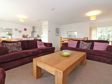 A living room with two maroon sofas and a wooden coffee table at Tamar Cottages 35 in St Ann's Chapel Cornwall