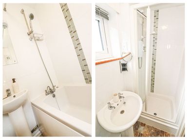 A bathroom with a bathtub, a shower, a sink, and a window at Tamar Cottages 35 in St Ann's Chapel Cornwall
