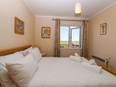 A bedroom with a bed and window at Boa Vista in Bacton