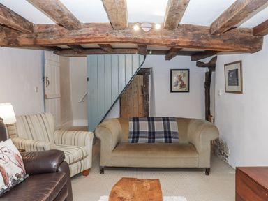 A living room with a sofa and armchair at Westacombe Farm in Dunsford near Tedburn St Mary