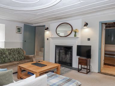 A living room with a coffee table and TV at Westacombe Farm in Dunsford