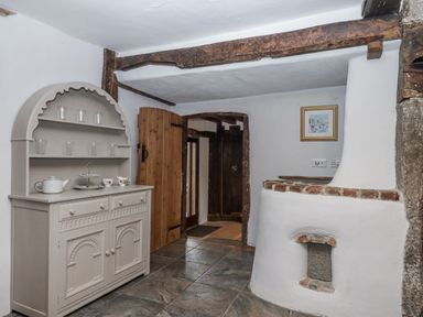 A kitchen with a cupboard and a door at Westacombe Farm in Dunsford