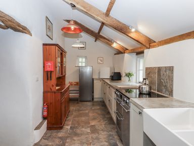 A kitchen with a refrigerator, sink, and oven at Westacombe Farm Dunsford
