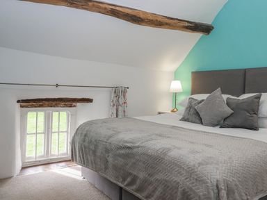 A bedroom with a bed and a window at Westacombe Farm in Dunsford