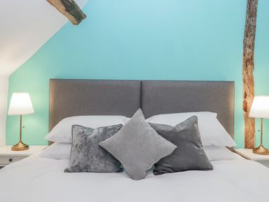 A bedroom with a bed and lamps at Westacombe Farm in Dunsford
