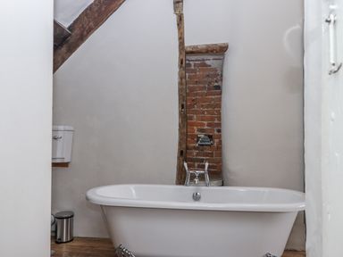 A bathroom with a bathtub and a toilet at Westacombe Farm in Dunsford