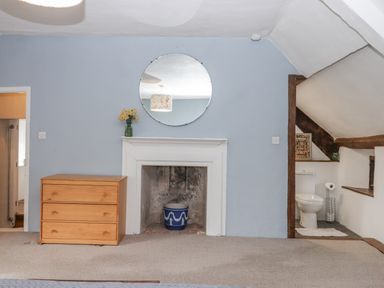A bedroom with a chest of drawers and a mirror at Westacombe Farm in Dunsford