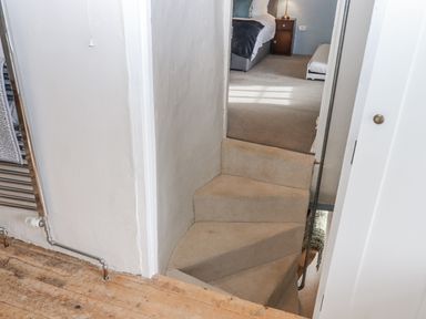 A staircase leading to a bedroom at Westacombe Farm in Dunsford