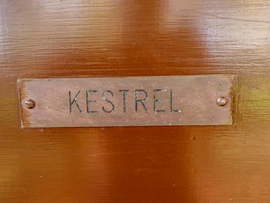 A metal nameplate with the word KESTREL mounted on a wooden surface at Kestrel in Withern near Alford