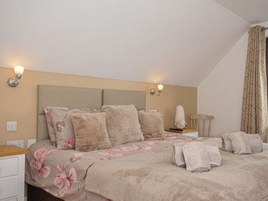 A bedroom with a bed and lamps at Kernyk in Camelford