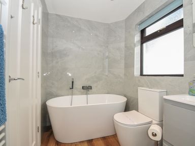 A bathroom with a bathtub and toilet at Kernyk in Camelford
