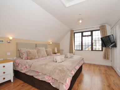 A bedroom with a bed and television at Kernyk in Camelford