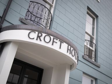 Building exterior with windows and black metal balcony railings at No 10 Croft House in Tenby