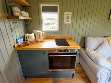 A kitchen with appliances and seating at Bluebell in Grimsby