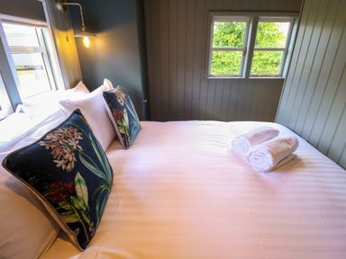 A bedroom with a bed, pillows, and towels at Bluebell in Grimsby