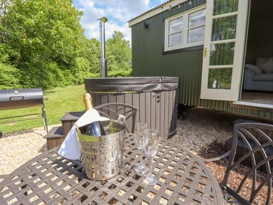 A table with ice bucket and champagne on a patio at Bluebell in Grimsby