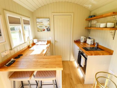 A kitchen with a sink and stove at Magnolia in Grimsby