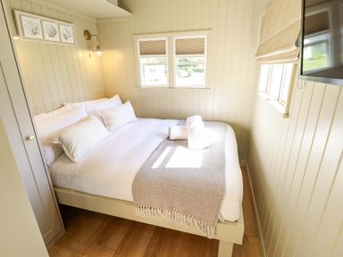 A bedroom with a bed and windows at Magnolia in Grimsby