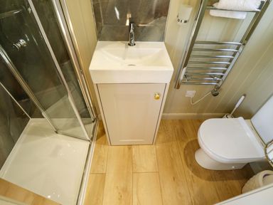 A bathroom with a sink, shower, and toilet at Magnolia in Grimsby