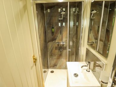 A bathroom with a shower and sink at Magnolia in Grimsby