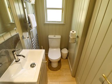 A bathroom with a sink and toilet at Magnolia in Grimsby