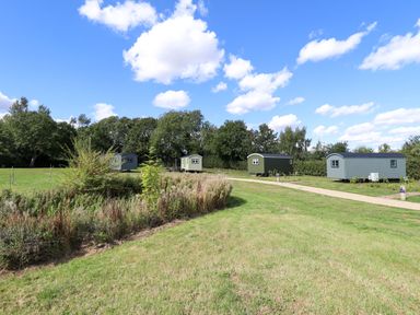A view of multiple huts on grassy land at Magnolia in Grimsby