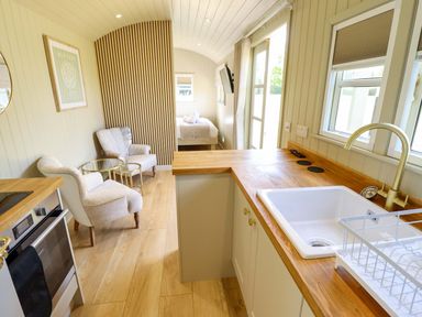 A kitchen with appliances and seating area at Snowdrop in Grimsby